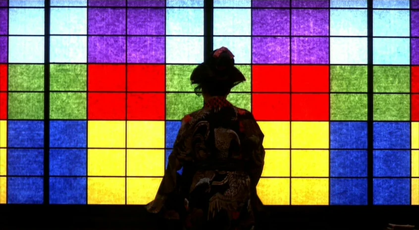 Sakuran (2006) movie still: medium — A dark, silhouetted figure stands in front of a shoji-style wall grid. The paper panels behind the figure are…