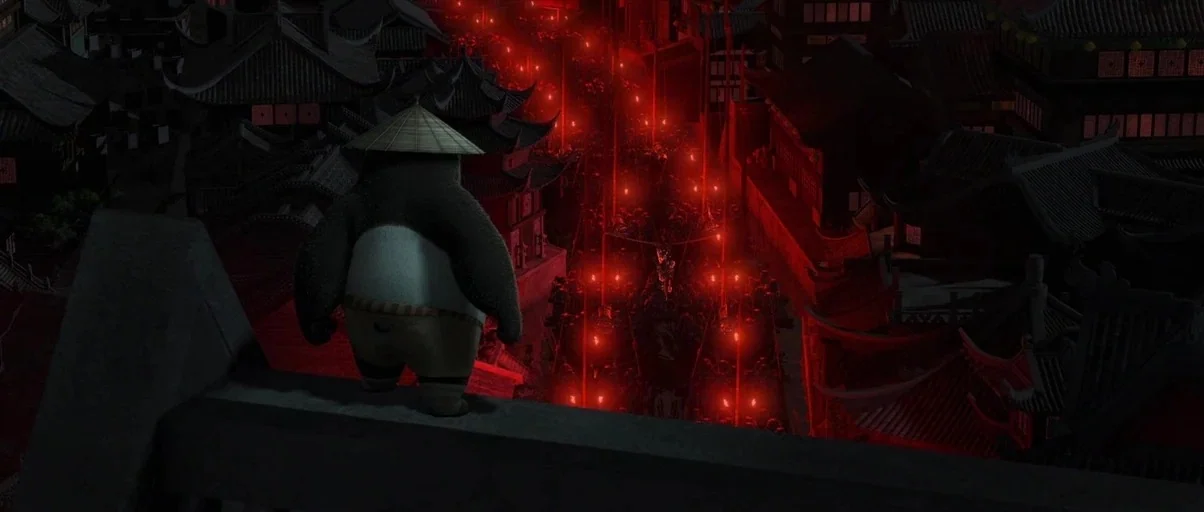 Kung Fu Panda 2 (2011) movie still: medium — A dark, stylized ancient Asian town is illuminated by intense red glowing lines. A panda wearing a…