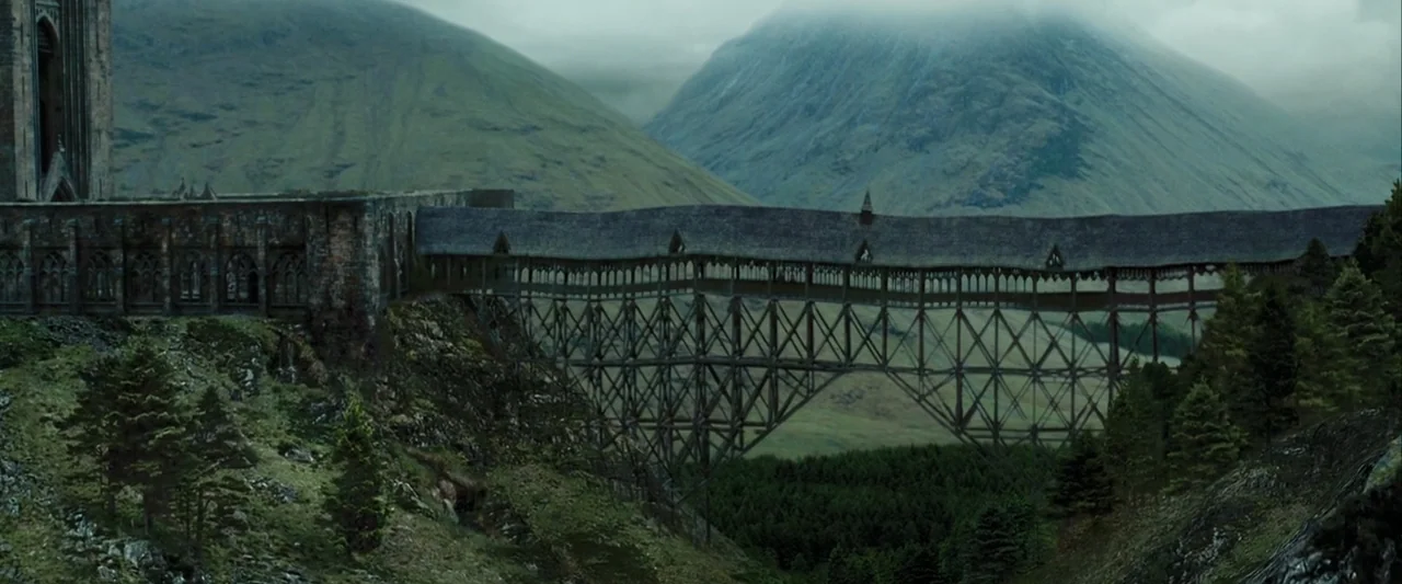 Harry Potter and the Prisoner of Azkaban (2004) movie still: establishing — A long, covered timber and stone viaduct stretches across a deep valley…