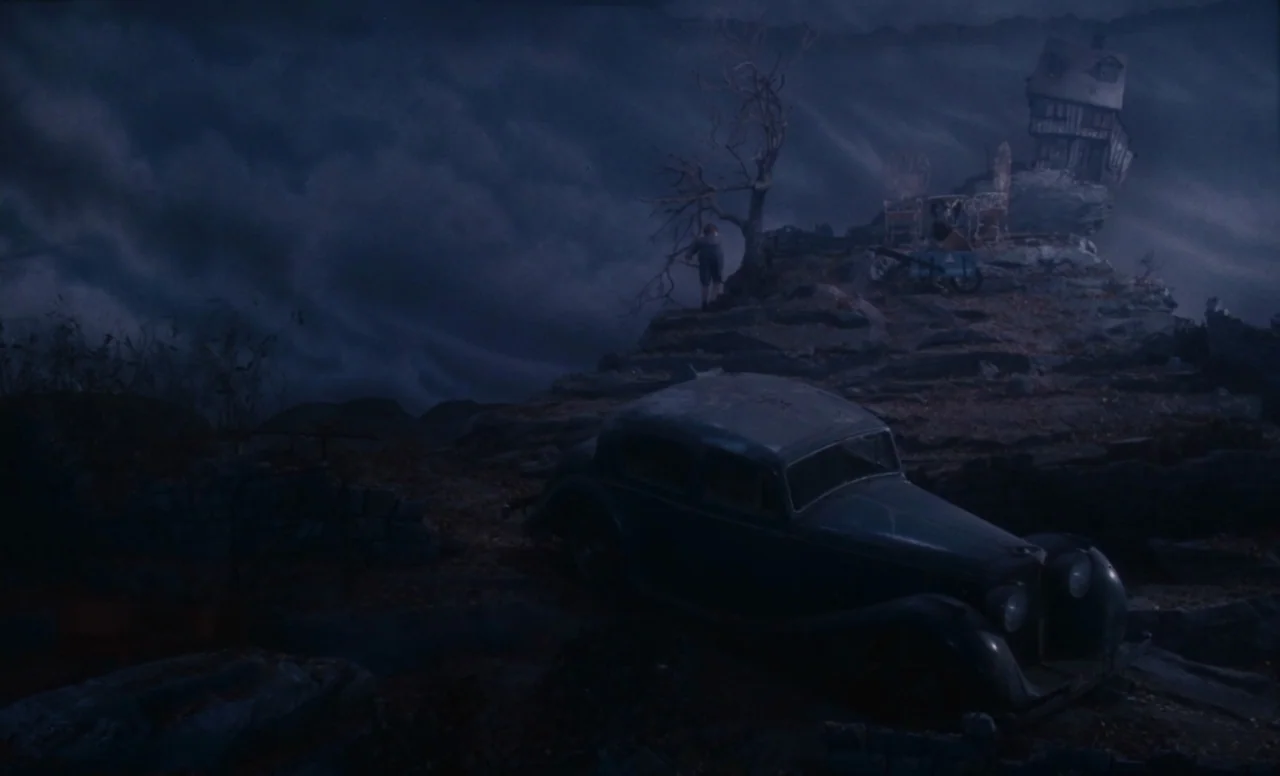 James and the Giant Peach (1996) movie still: wide — A desolate, rocky hillside is illuminated under a dark, storm-filled night sky. An abandoned…