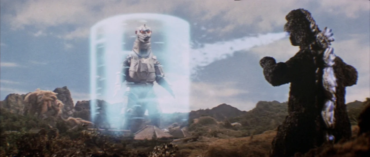 Godzilla Vs Mechagodzilla (1974) movie still: wide — A mountainous landscape features a rocky terrain with small traditional Japanese structures…