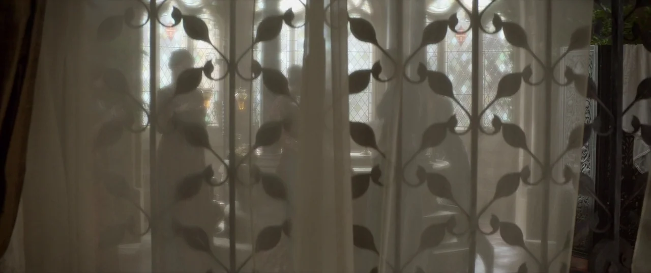 Ophelia (2018) movie still: medium — A light-filled room features stained glass windows partially obscured by a delicate patterned lace curtain.…