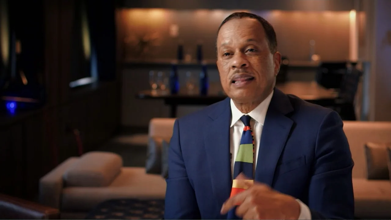 Ali & Cavett: The Tale of the Tapes (2018) movie still: medium — A man sits in an office with blurred furniture in the dark background. He is…