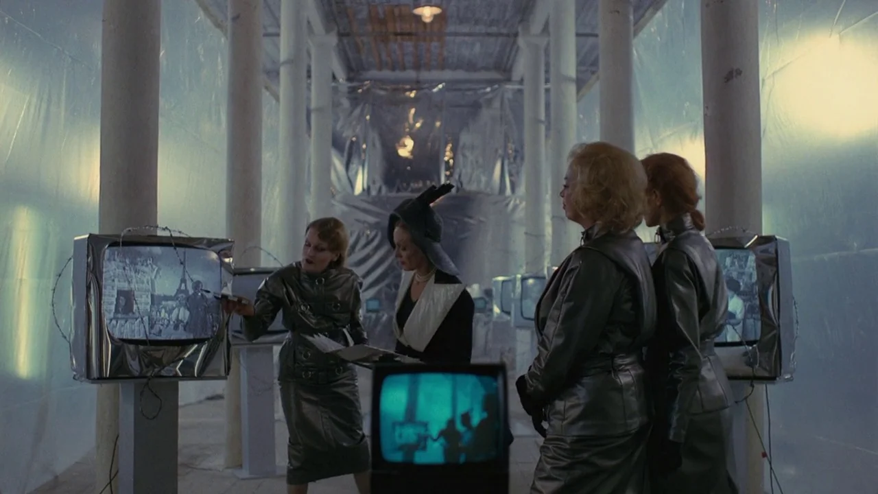 Dorian Gray in the Mirror of the Yellow Press (1984) movie still: medium — A high-ceiling space lined with concrete columns and walls covered in…