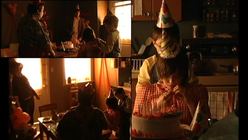 The Tracey Fragments (2007) movie still: medium — A dimly lit interior space features a birthday party setup with a decorated cake. A young person…