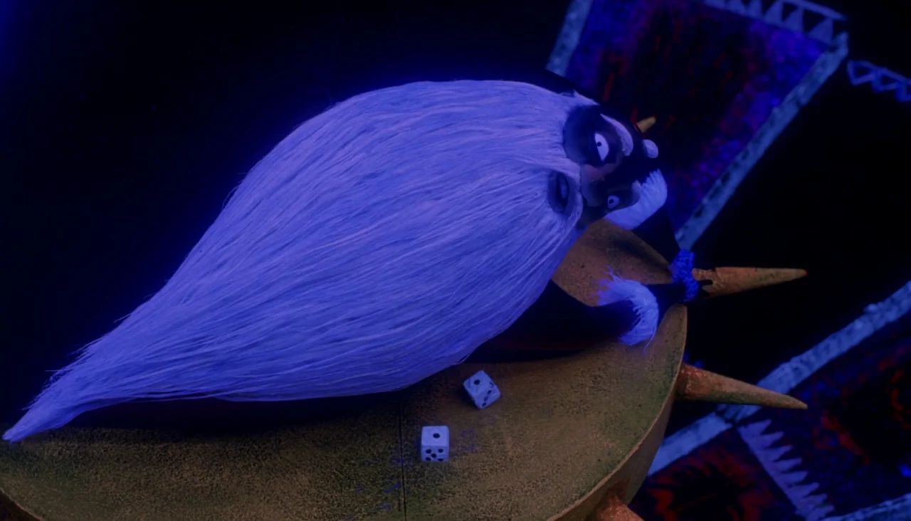 The Nightmare Before Christmas (1993) movie still: medium — A dark room features a round table with large metal spikes along the edge. The character…