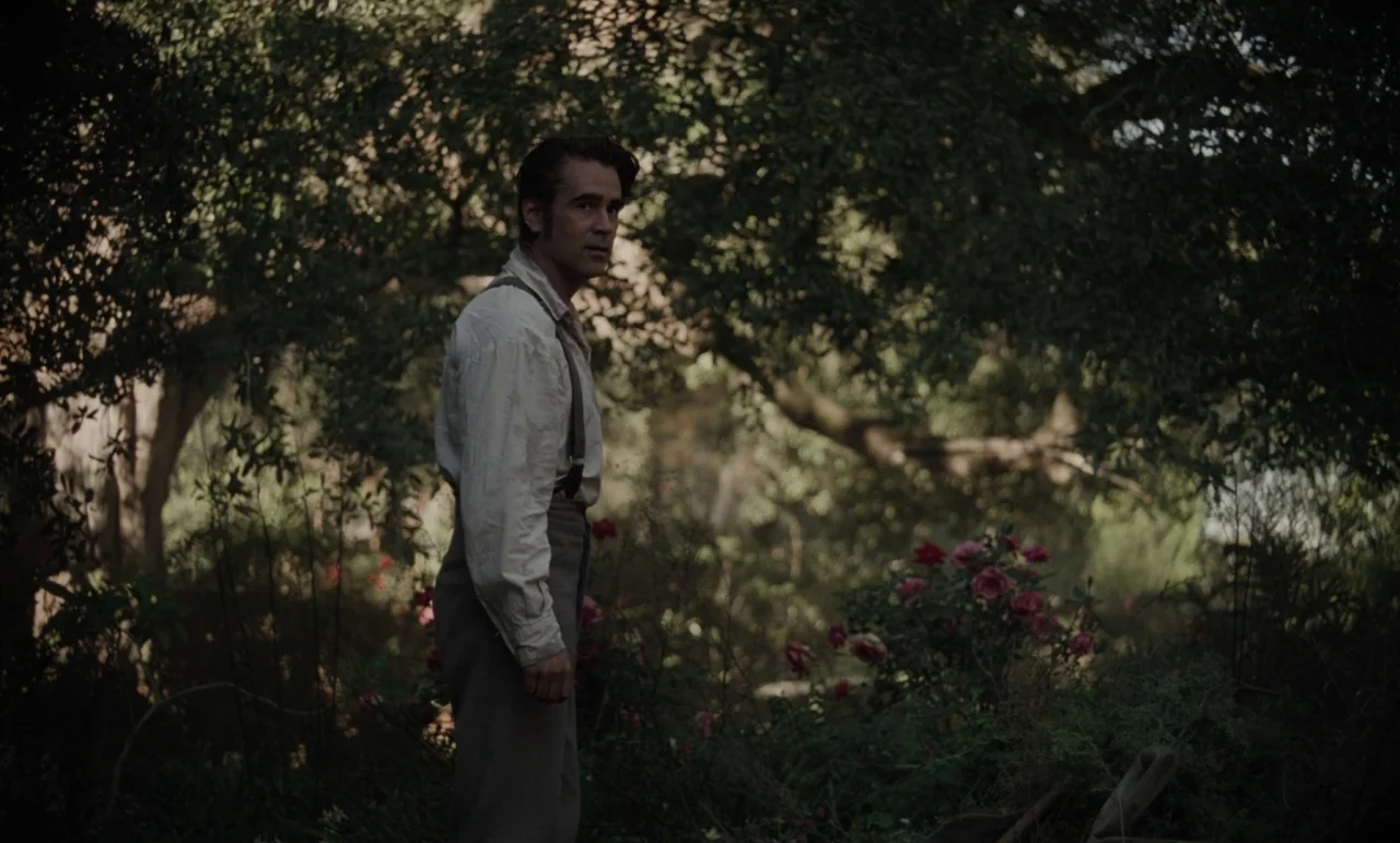 The Beguiled (2017) (2017) movie still: fullbody — A dense overgrown woodland area features dark foliage and small clusters of red flowers. A man…