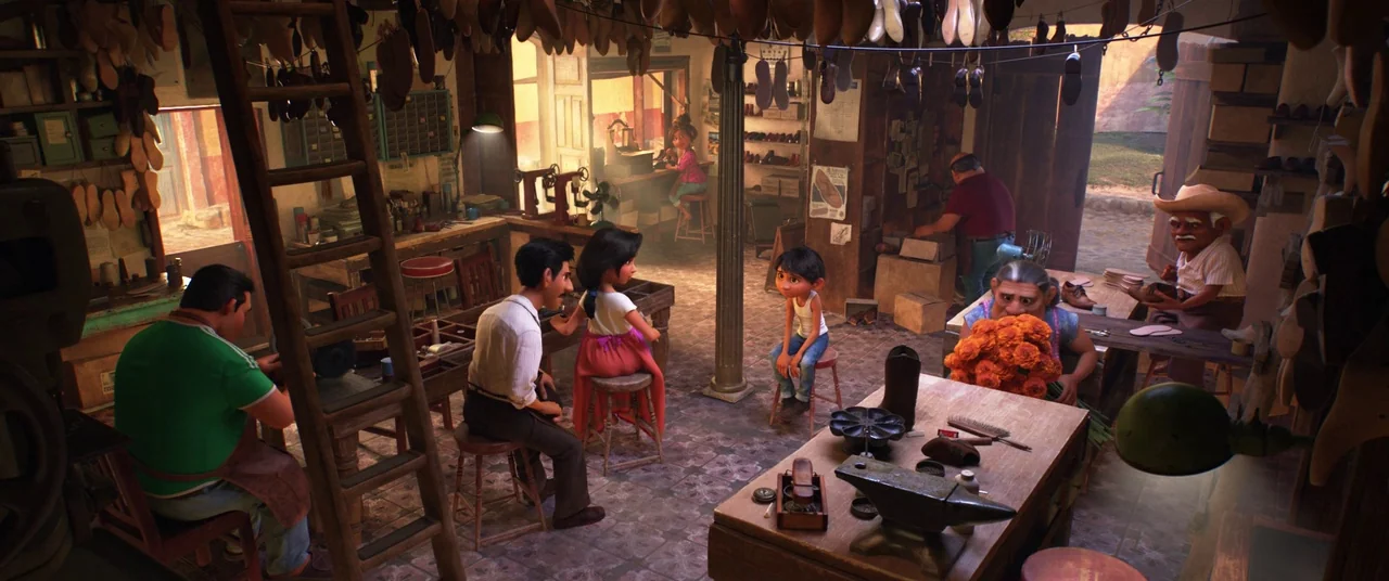 Coco (2017) movie still: wide — A rustic cobbler workspace filled with hanging shoe forms and various hand tools. Several people are occupied with…