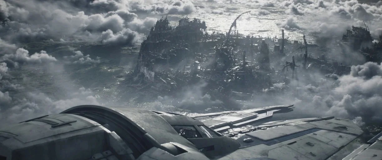 The Mandalorian (2019) movie still: establishing — A dense layer of clouds partially obscures a ruined city with collapsed skyscrapers. A futuristic…