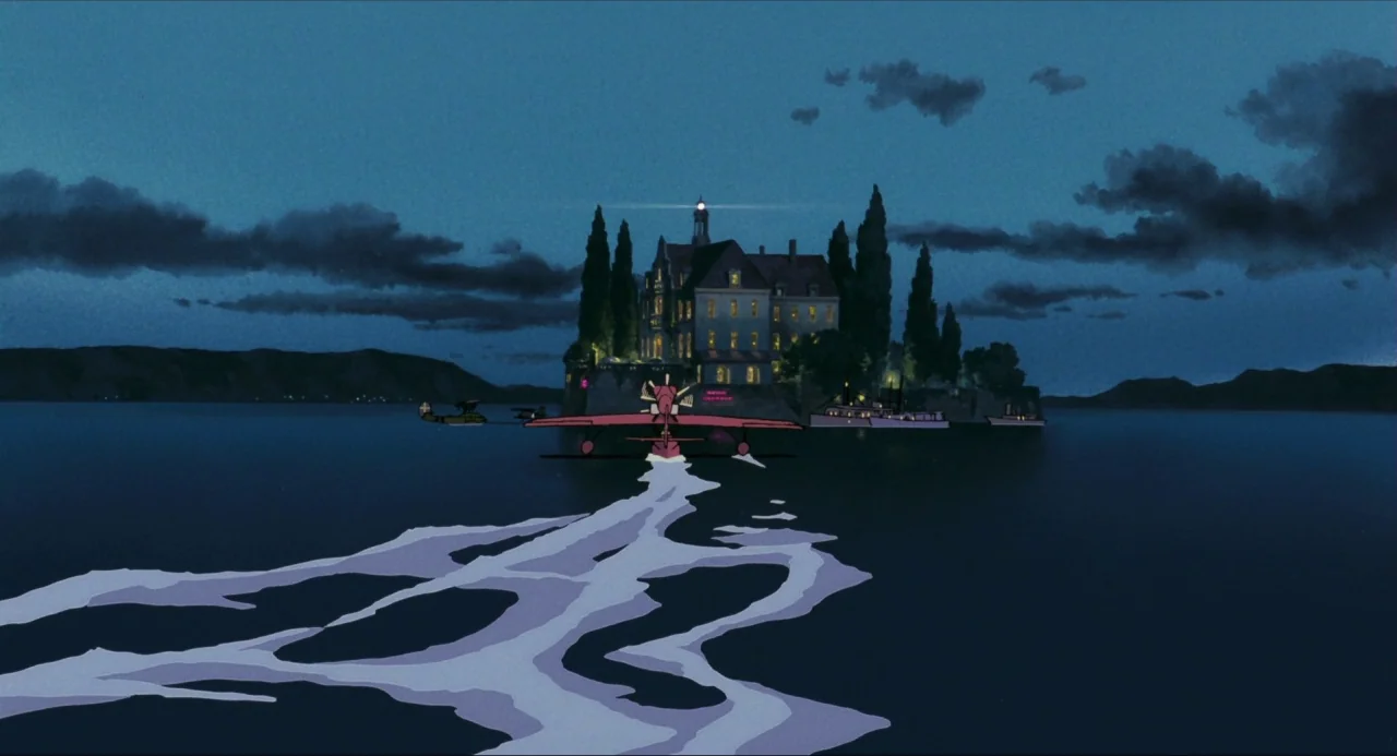 Porco Rosso (1992) movie still: wide — A dark blue seascape surrounds a small island dominated by a large European mansion. A red seaplane creates a…