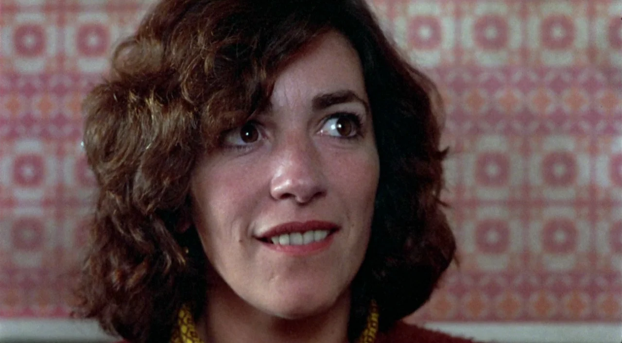 What Have I Done To Deserve This? (1984) movie still: closeup — An interior space features a wall with a repetitive vintage floral or geometric…