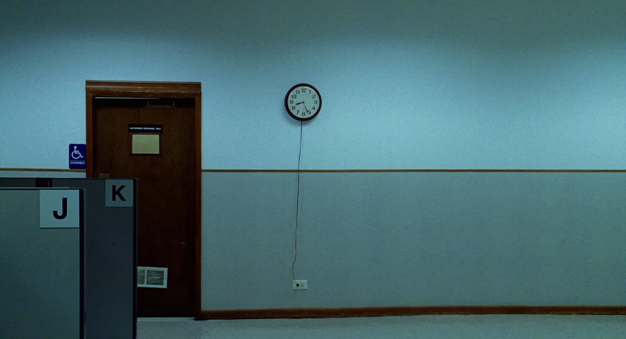 The Weather Man (2005) movie still: establishing — An empty office corridor features pale blue walls with a horizontal divider strip. A single…
