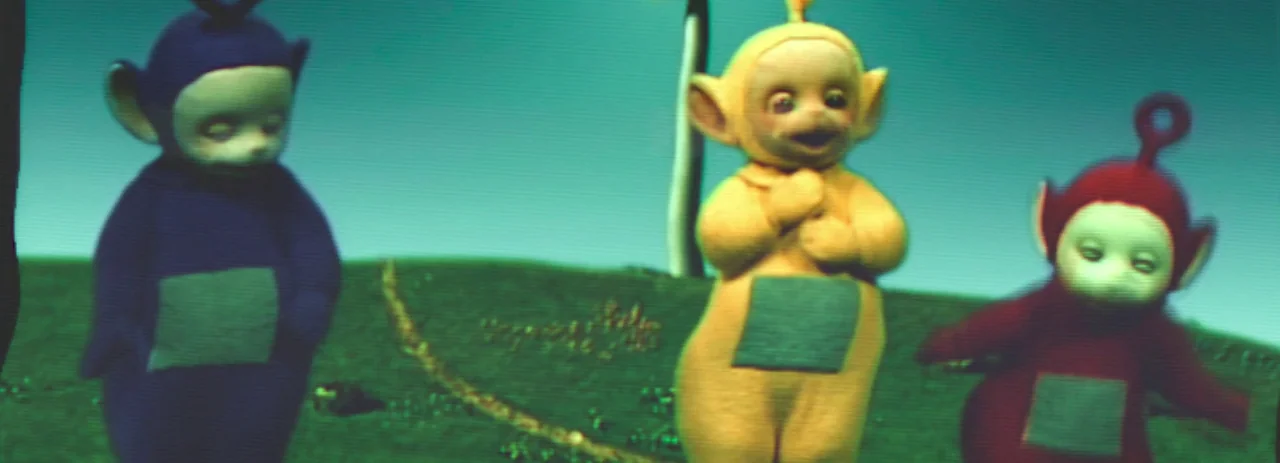 28 Years Later (2025) movie still: fullbody — A green hill with a bright blue sky backdrop features three colorful creatures. The characters are…
