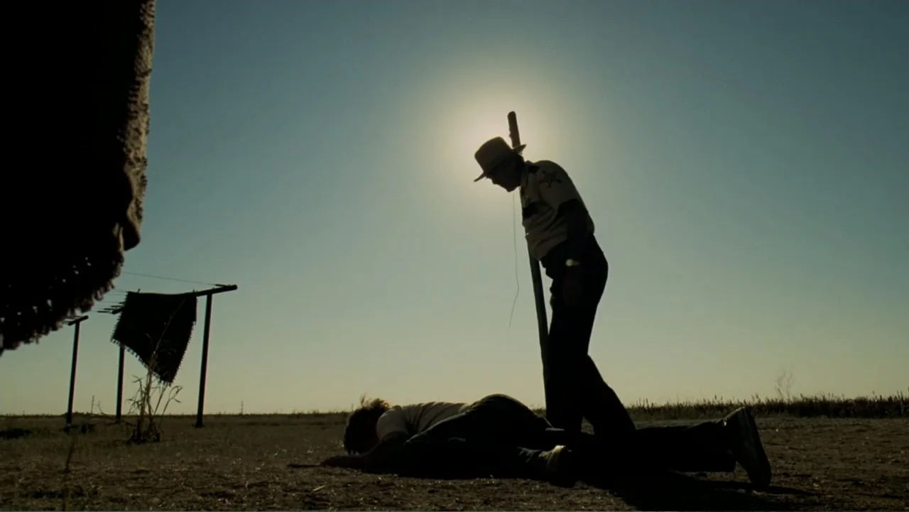 The Texas Chainsaw Massacre: The Beginning (2006) movie still: wide — A flat, sun-bleached landscape features a thin line of distant horizon under…