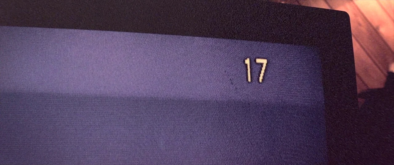 Skinamarink (2022) movie still: closeup — A close-up view of a digital display showing the number seventeen on a screen. The image contains visible…