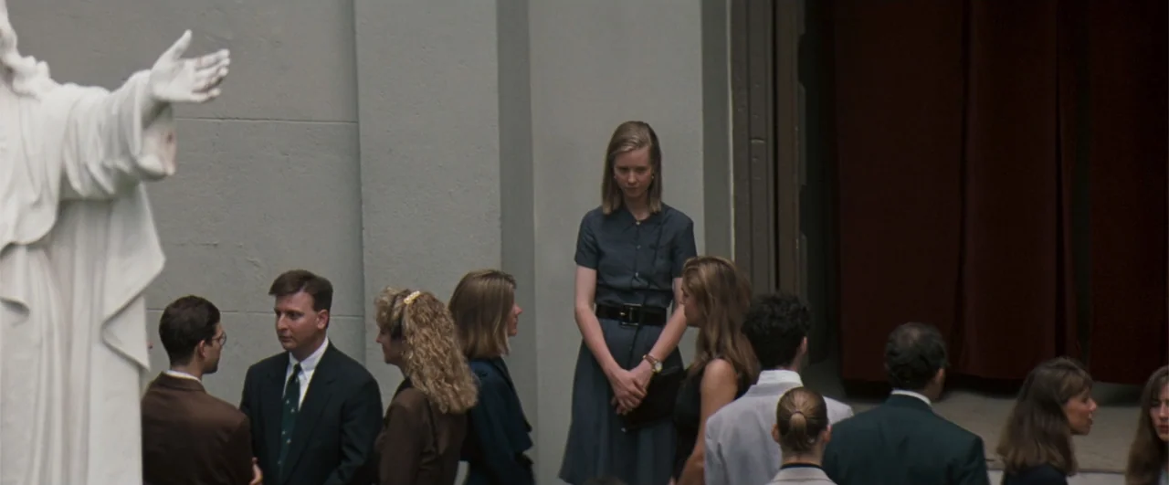 The Pelican Brief (1993) movie still: medium — A group of people dressed in business attire stands in an outdoor courtyard area. A woman in a grey…