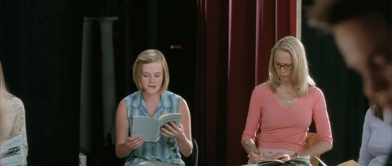 A Walk to Remember (2002) movie still: medium — A group of young women sit in a brightly lit room with dark curtains. They are seated in chairs and…