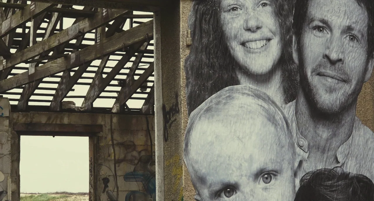Faces Places (2017) movie still: medium — An abandoned concrete building features an open roof structure with exposed timber rafters. A large…