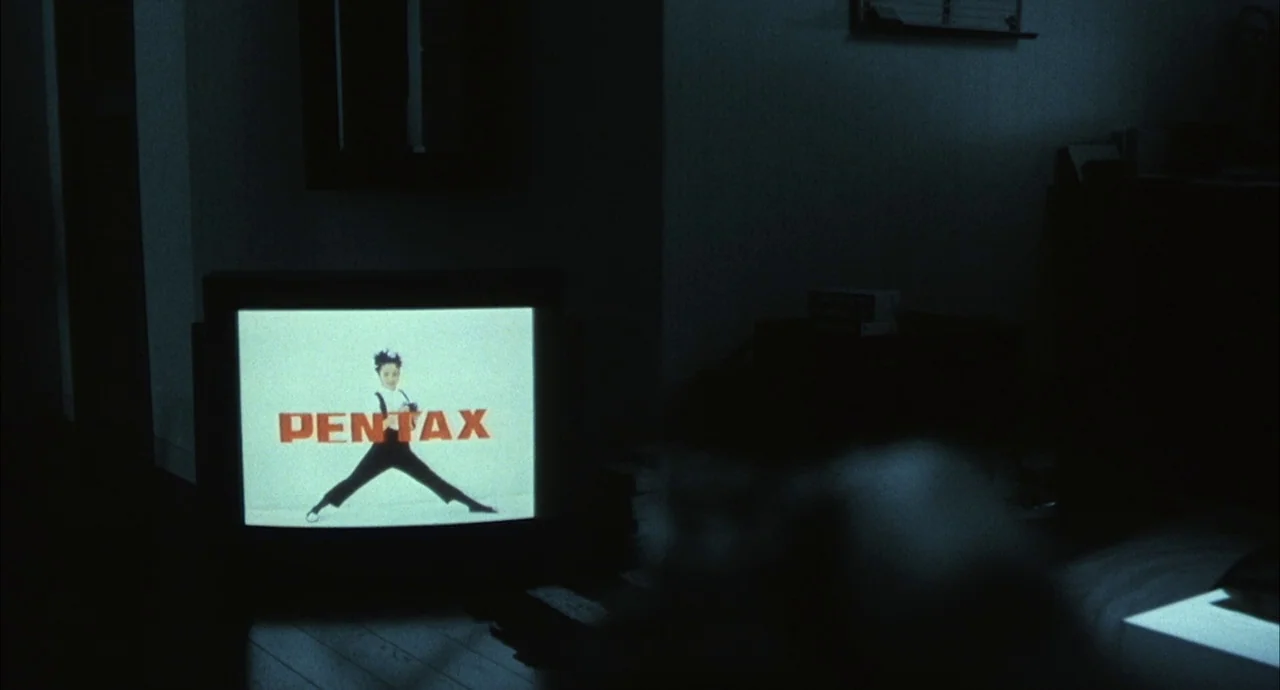 The Discarnates (1988) movie still: medium — A dark living room is lit only by the illumination of a CRT television set. The television screen…