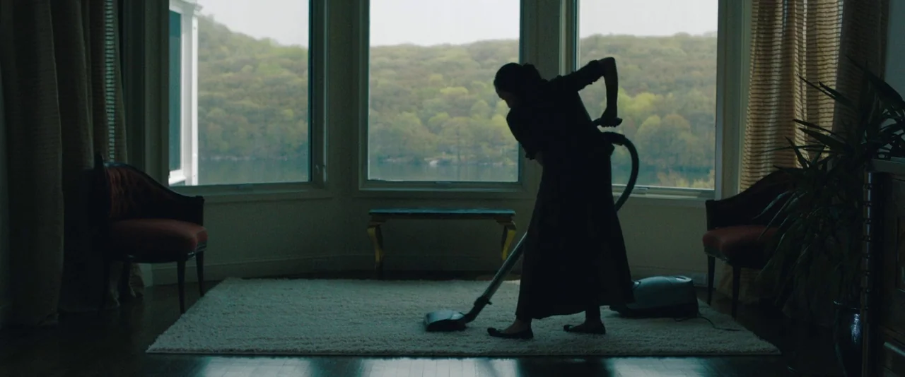 Kiss of the Damned (2012) movie still: fullbody — A windowed room looks out over a lake and green trees during the day. A woman in dark clothing…