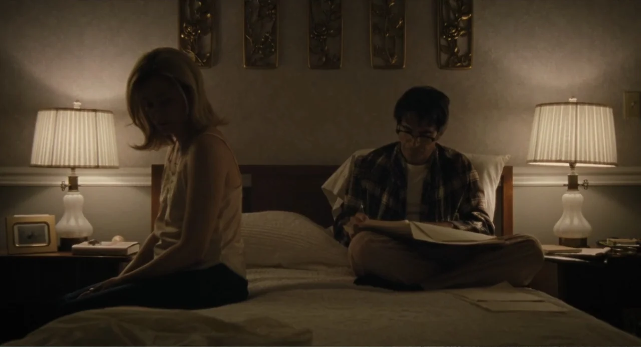 Call Jane (2022) movie still: medium — A dimly lit bedroom features twin bedside lamps and wall decor above the headboard. A woman and man occupy…