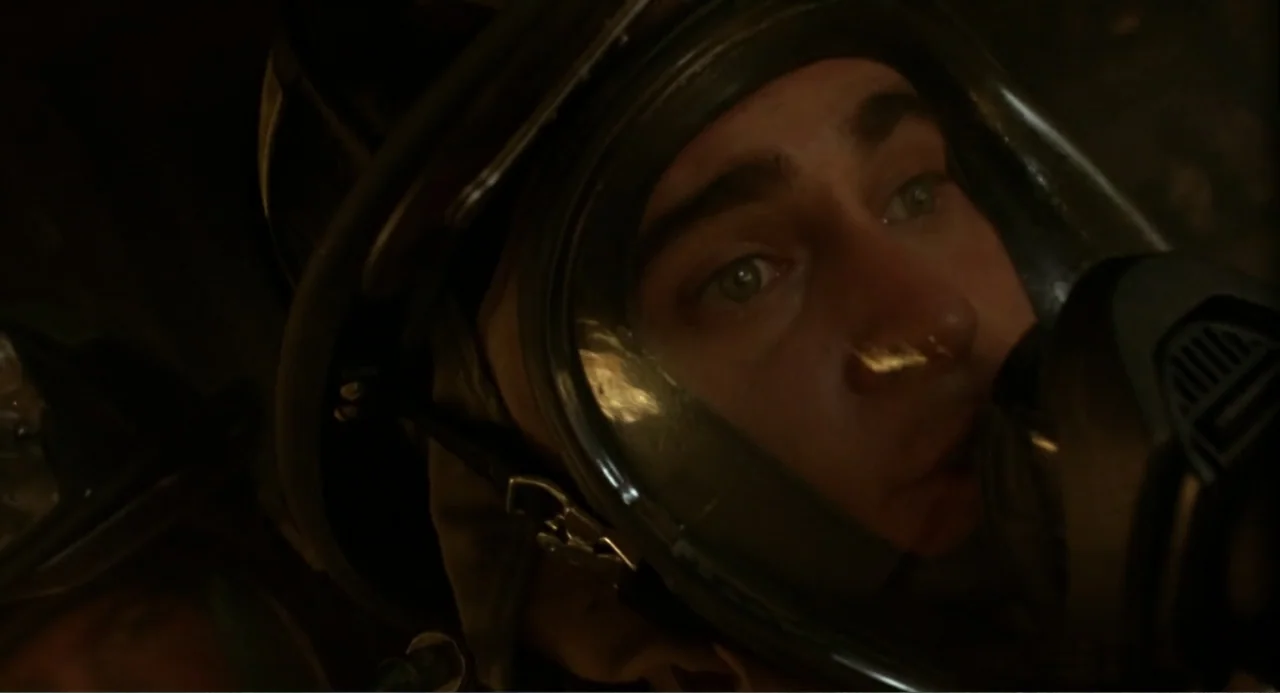 Ladder 49 (2004) movie still: closeup — A dark, confined environment surrounds a person wearing a full-face protective respirator mask. The…