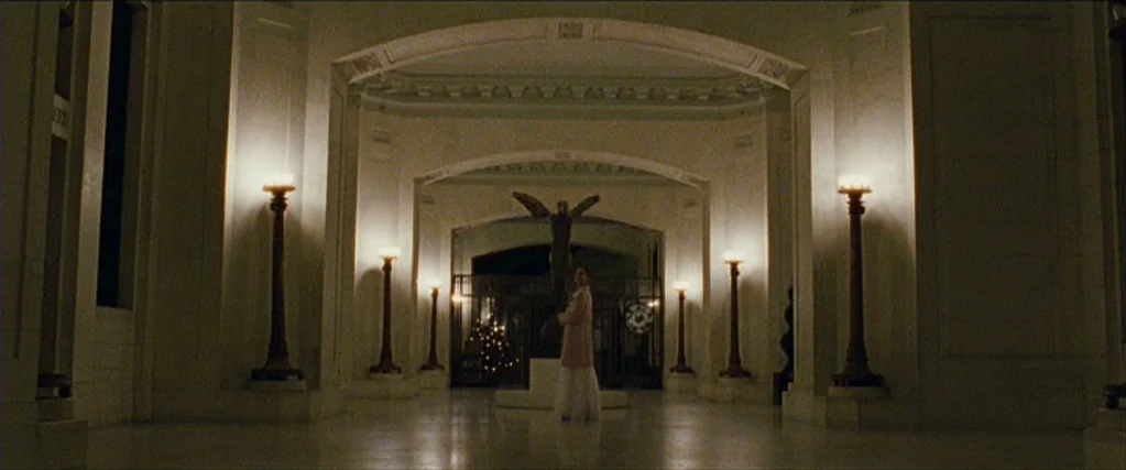 Black Swan (2010) movie still: wide — A spacious, neoclassical marble building interior features symmetrical columns and recessed lighting fixtures.…