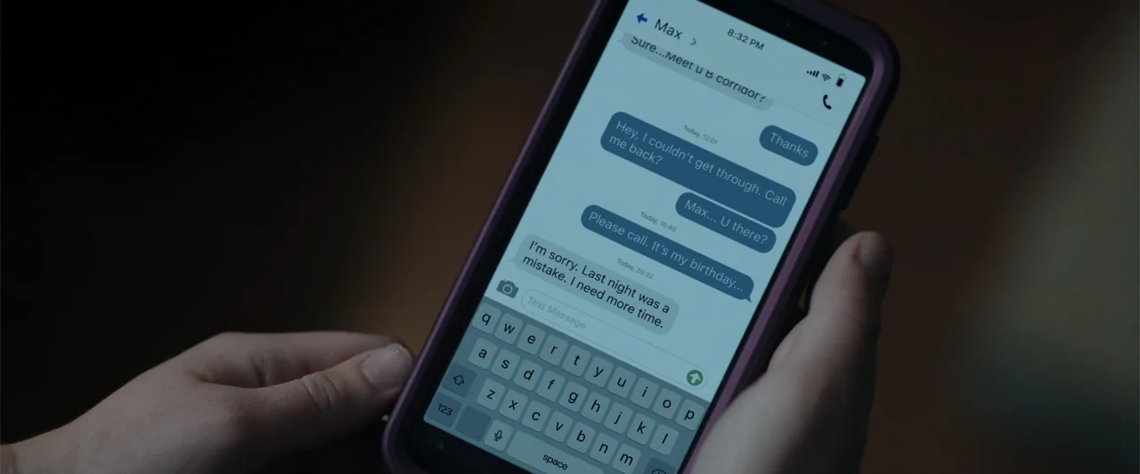 Nocturne (2020) movie still: closeup — A pair of human hands holds a smartphone displaying a text message conversation. The screen shows a series of…
