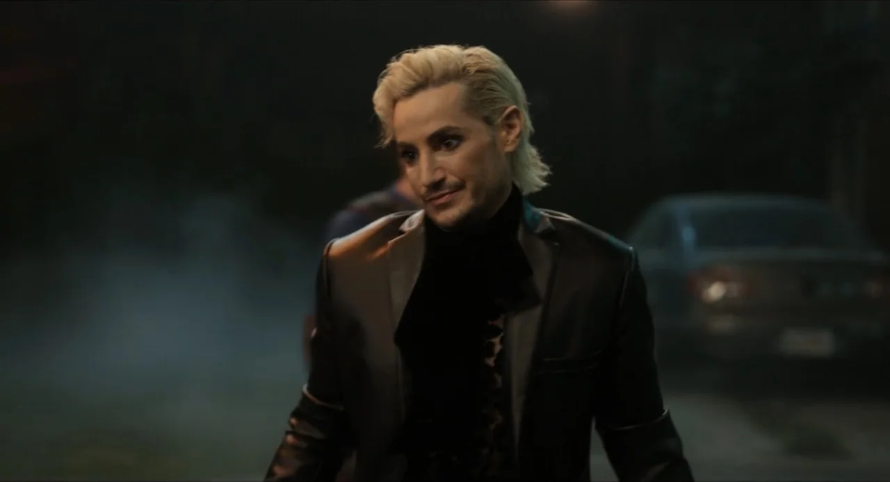 Henry Danger: The Movie (2025) movie still: medium — A dark driveway at night with a blurred car visible in the background. A man with bleached…