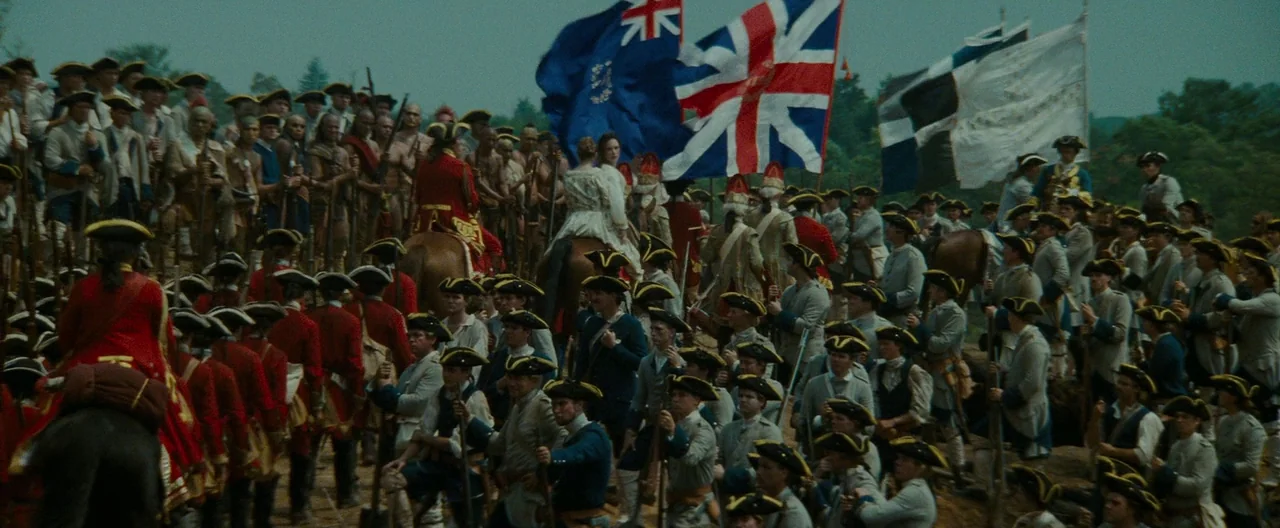 The Last of the Mohicans (1992) movie still: wide — A dense gathering of 18th-century soldiers in field uniforms stands in an open clearing. British…