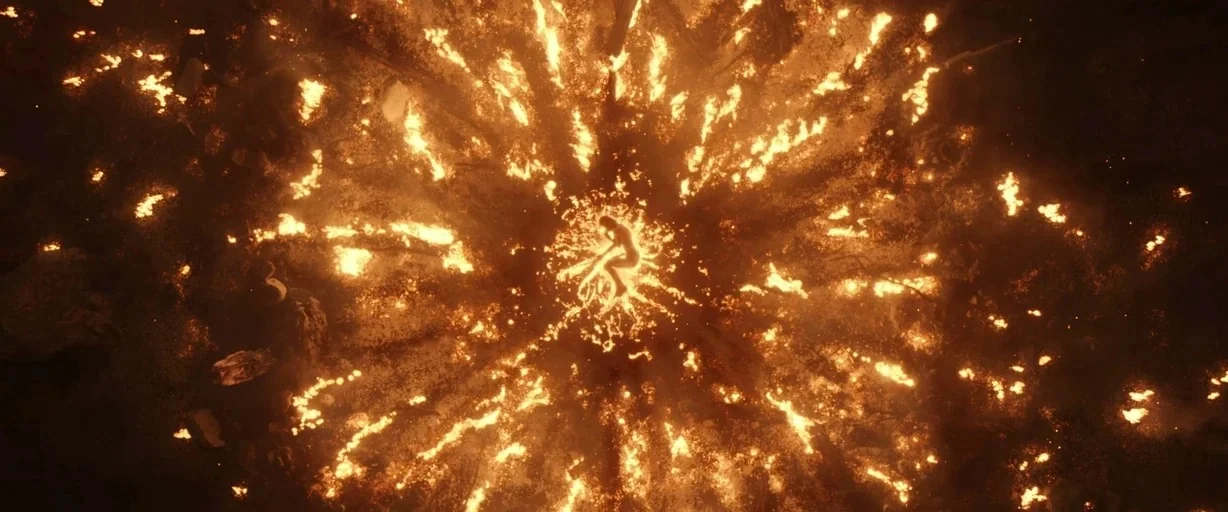 The Lord of the Rings: The Rings of Power (2022) movie still: wide — A dark ground is covered in embers radiating outward from a central fiery…