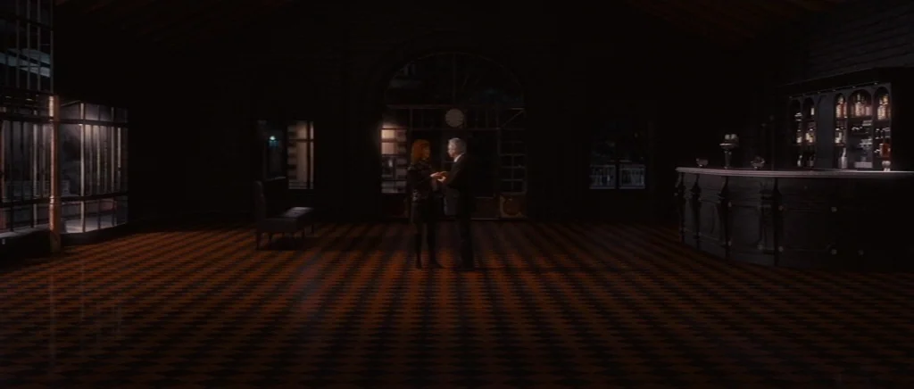 You Ain’t Seen Nothin’ Yet (2012) movie still: wide — A spacious, dark interior features a checkered floor and a wooden bar in back. A man and a…