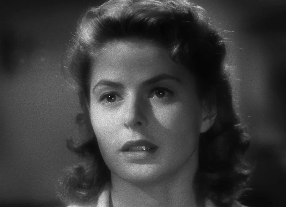 Spellbound (1945) movie still: closeup — A close-up shot focusing on a woman within a dimly lit interior space. The woman looks directly off-camera…