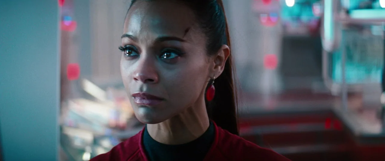 Star Trek Into Darkness (2013) movie still: closeup — A high-tech control station features dark panels with glowing blue and red indicator lights. A…