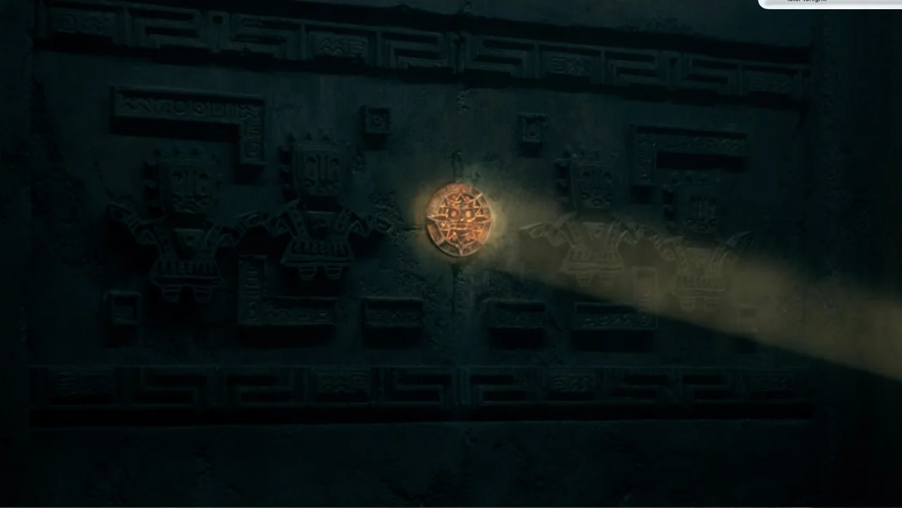 Dora and the Lost City of Gold (2019) movie still: medium — An ancient stone wall features carved figures flanking a central glowing circular disc.…