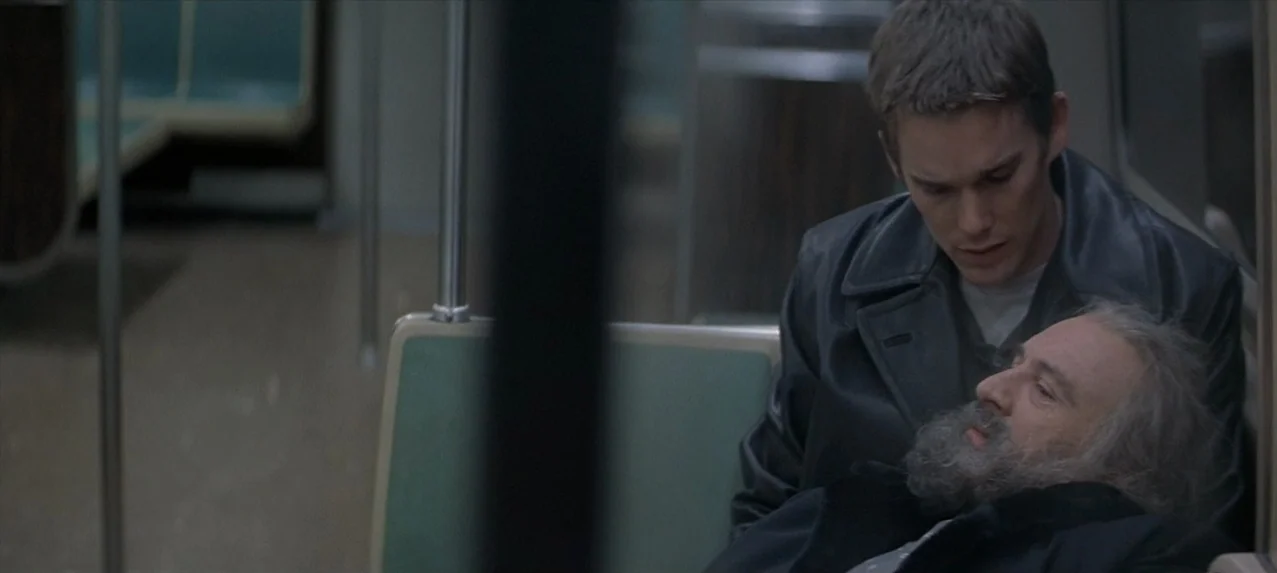 Great Expectations (1998) movie still: medium — A quiet public transit interior features olive green seats and silver vertical handrails. A young…