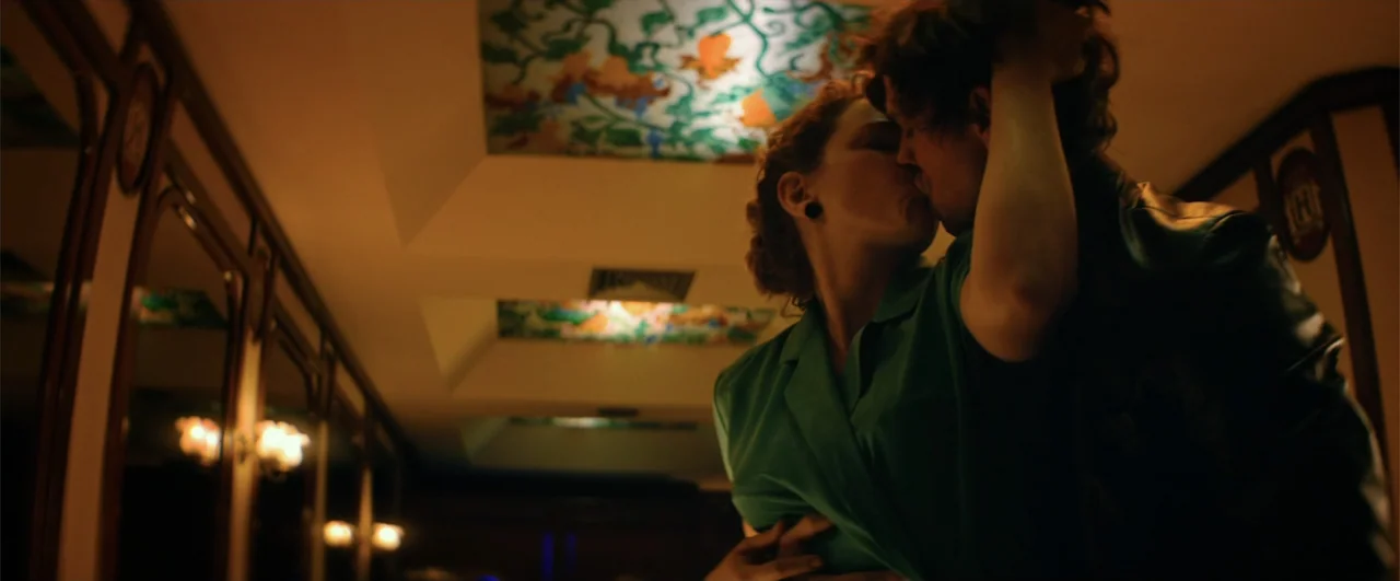 Bingo: The King of the Mornings (2017) movie still: medium — A dimly lit narrow hallway features mirror panels on one side and recessed ceilings. A…