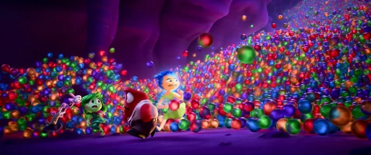 Inside Out 2 (2024) movie still: wide — A dark, cavernous space is filled with a vast accumulation of colorful spheres. Four animated characters…