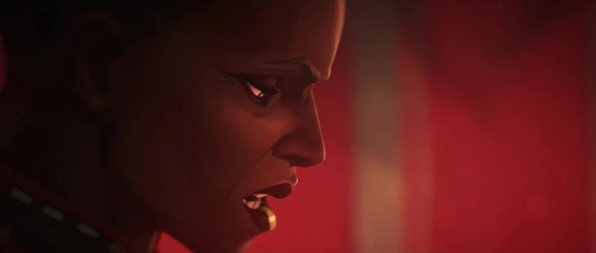 Arcane (2024) movie still: closeup — A dimly lit interior space is bathed in intense red light. A dark-skinned woman with short hair speaks while…