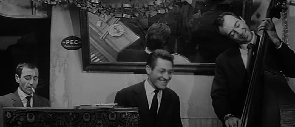 Shoot The Piano Player (Tirez Sur Le Pianiste) (1960) movie still: medium — An indoor club setting with a large wall mirror behind a musical…