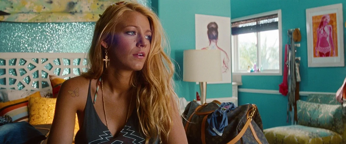 Savages (2012) movie still: medium — A vibrant room with turquoise walls decorated with colorful artwork and patterned textiles. A young blonde…