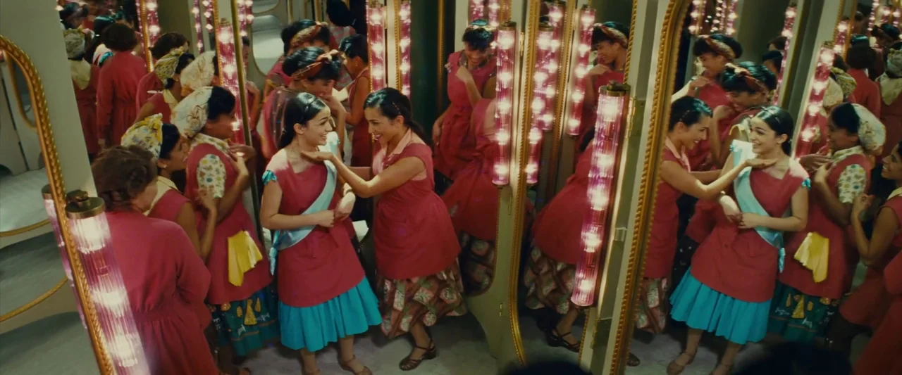 Making of: West Side Story (2021) movie still: medium — A room filled with multiple standing mirrors framed in gold and lighted vertical lamps.…