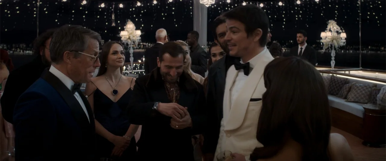 Operation Fortune: Ruse de Guerre (2023) movie still: medium — An outdoor yacht deck at night features a group of formally dressed people…