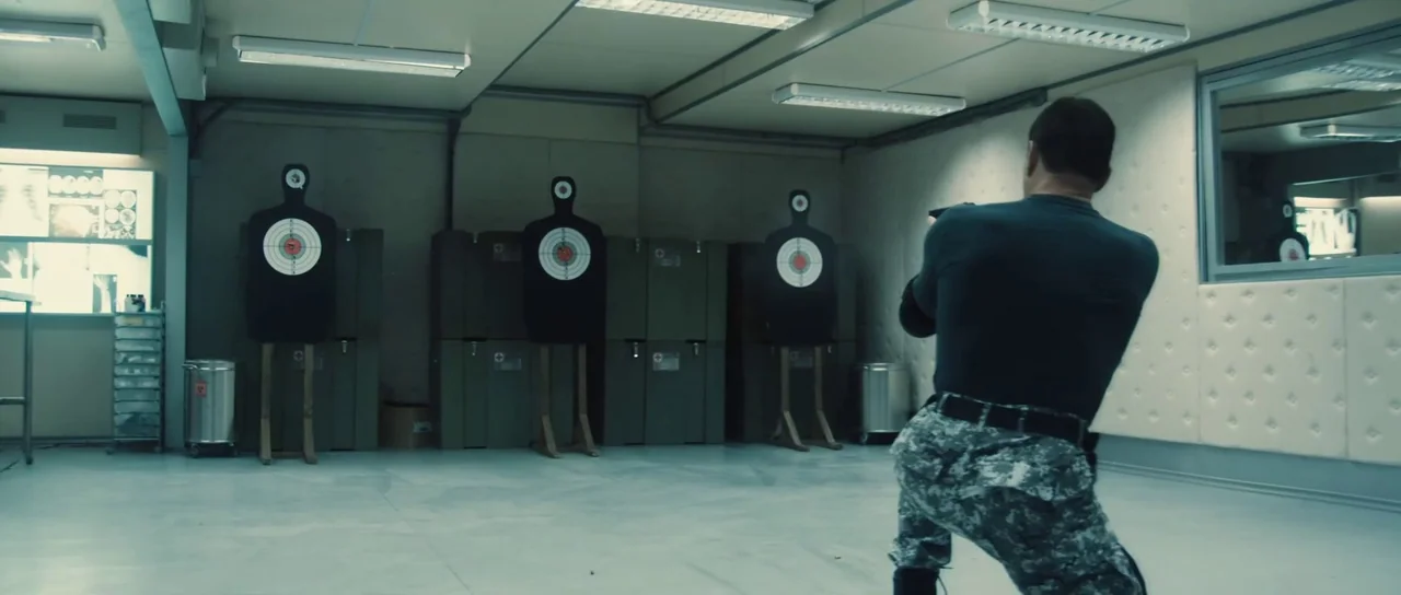 Universal Soldier: Regeneration (2009) movie still: medium — A utilitarian training space with gray walls and a smooth floor features three targets.…