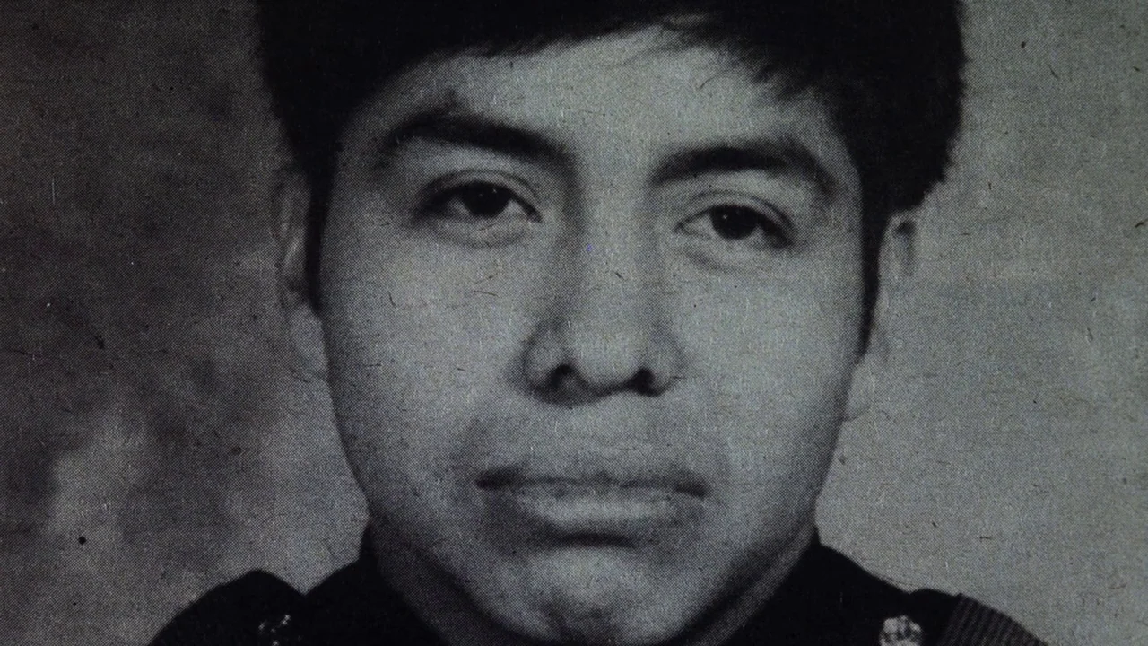 The Thin Blue Line (1988) movie still: closeup — A grainy black and white portrait of a young man against a plain background. The subject stares…
