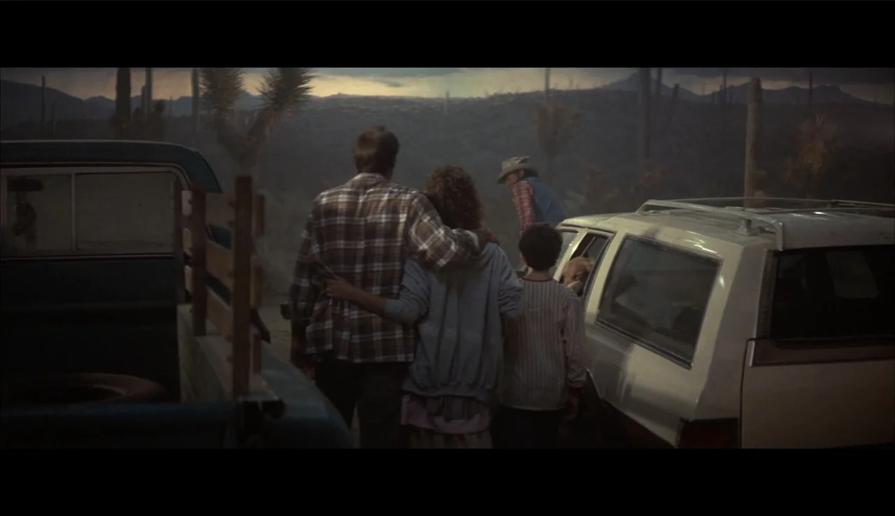 Poltergeist II: The Other Side (1986) movie still: wide — A dusty arid landscape at twilight features scattered yucca plants and distant mountains.…
