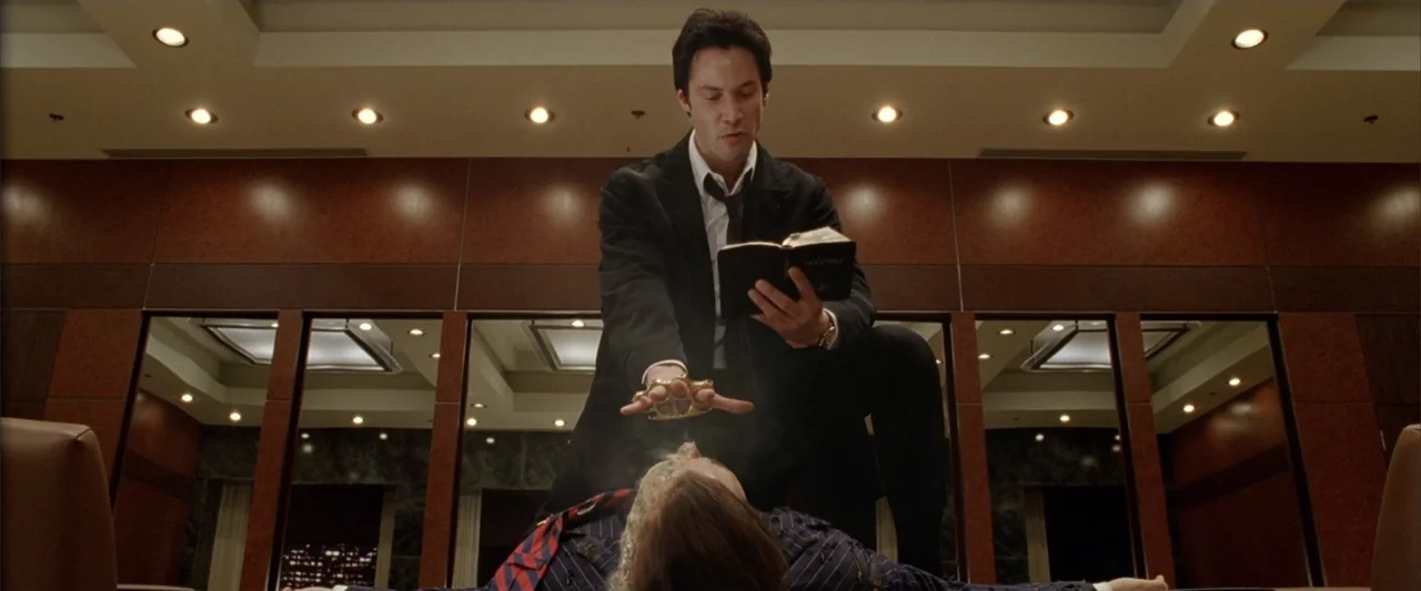 Constantine (2005) movie still: medium — A modern, wood-paneled space features large rectangular mirrors mounted on the walls. A man wearing a suit…