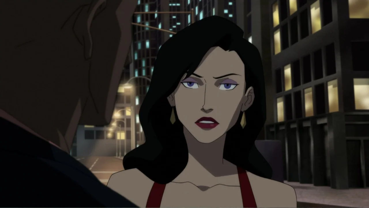 Reign of the Supermen (2019) movie still: medium — A night scene on a city street with dark buildings and lit windows behind. A woman in a red top…