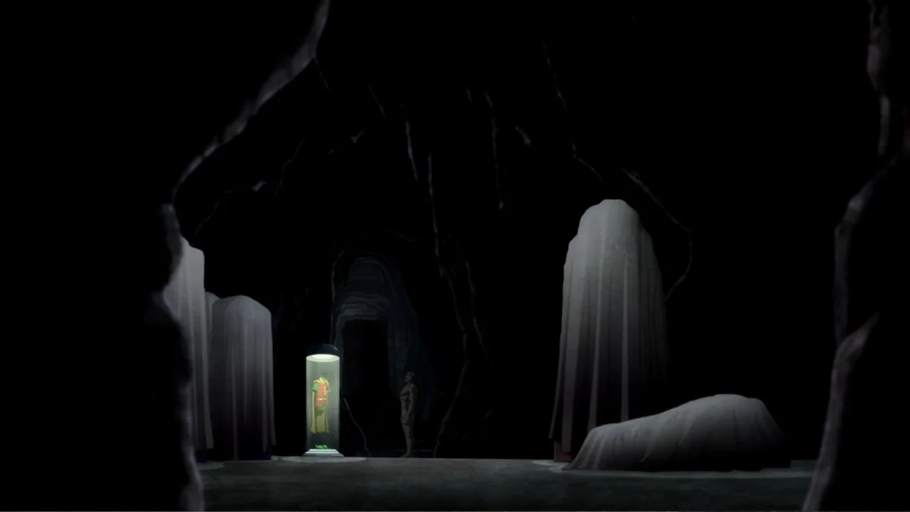 Batman: The Dark Knight Returns, Part 1 (2012) movie still: wide — A dark, expansive cave contains multiple shrouded vertical objects and a lit…