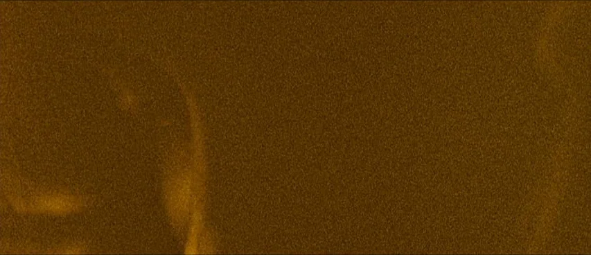 This Movie Is Broken (2010) movie still: establishing — An expanse of fine textured sand grains fills the frame. Subtle shifting patterns indicate…